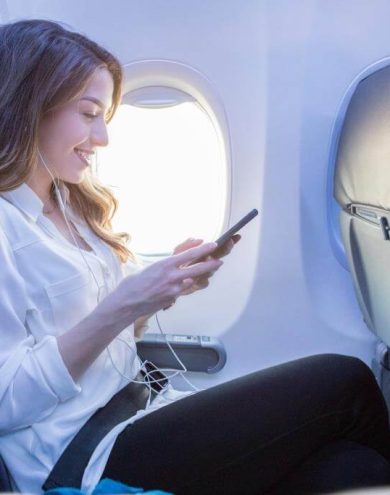 woman on phone in plane - Wireless IFE